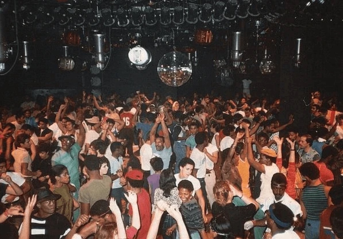 Paradise Garage dance floor with mirror balls and crowd.
